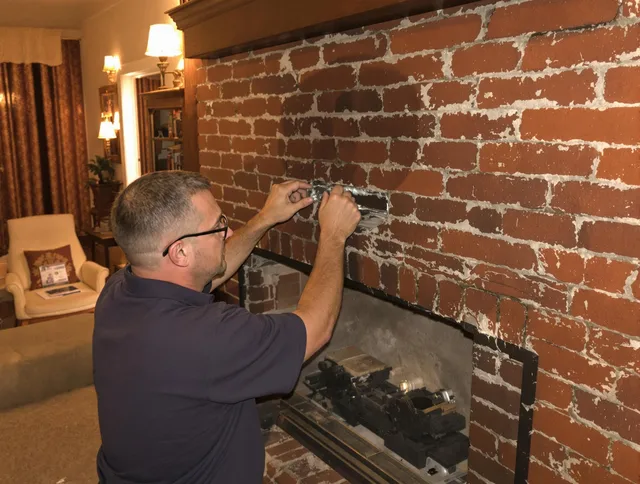 Akron Chimney Sweep expert fixing a fireplace in Akron, OH
